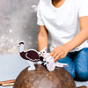 Person playing with animal figurines on a rock