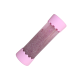 Pink and purple glittery cylindrical object on a white background