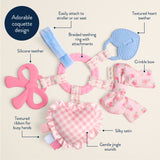 Baby teething ring with various attachments and features highlighted on a beige background