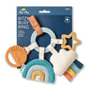 Colorful baby teething ring with various shapes on a blue packaging background