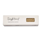 Close-up of Snuggle Hunny natural wooden baby hairbrush showing soft nylon bristles and engraved handle.