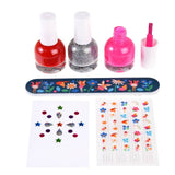 Set of nail polish bottles, a nail file with designs, and nail art stickers on a white background