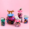 Colorful toys with animal figures on a pink background