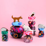 Colorful toys with animal figures on a pink background