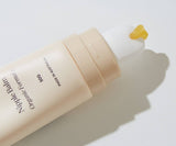 Nipple balm with a drop of balm on a white background