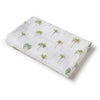 Folded fabric with palm tree pattern on a white background