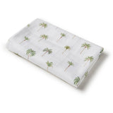 Folded fabric with palm tree pattern on a white background