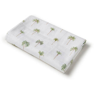 Folded fabric with palm tree pattern on a white background