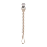 Beige pacifier clip with a beaded design on a white background