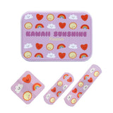 A set of three lavender band-aid style stickers with a cute repeating pattern of smiling suns, hearts, rainbows, and clouds, displayed with their matching zip case on a white background.