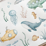 Watercolor-style underwater illustration on a white background, featuring a blue whale, yellow submarine, jellyfish, seahorse, fish, bubbles, and seaweed.