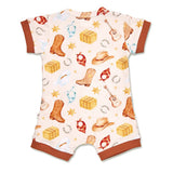 A baby short-sleeve romper with a western-themed print featuring cowboy boots, hats, horseshoes, and bales of cotton on a cream background, finished with brown ribbed cuffs and leg cuffs.