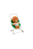 Plush toy octopus in a stroller on a white background