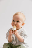 Baby holding a bottle with a white background