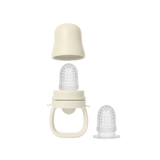 Baby bottle with nipple and two additional nipples on a white background