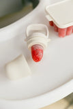 White silicone mold with a strawberry inside on a white surface