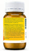 An amber glass bottle of teething relief powder with a white ribbed cap and a yellow label containing English directions and a barcode.