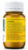 An amber glass medicine bottle with a white ribbed cap, showing the back of the label with text warnings and WELEDA branding on a white background.