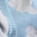Close-up of a blue fabric with white cloud patterns