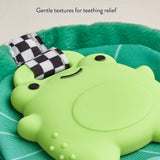 Green teething toy with checkered strap on a green background