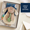 Plush bunny toy with rattle in a gift box, labeled 'Itzy Lovey', on a light background.