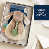 Plush bunny toy with rattle in a gift box, labeled 'Itzy Lovey', on a light background.