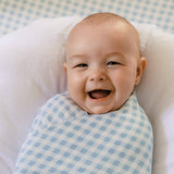 Baby wrapped in a blue and white checkered blanket with a checkered background