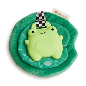 Green plush toy with a turtle design on a green base, featuring a checkered strap and a brand tag.