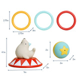 A baby sensory toy set with a polar bear figure on a red-and-white circus-style base, shown with dimension callouts and three hanging rings in yellow, light blue, and red on a white background.