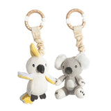 Two knitted baby toys, one resembling a cockatoo and the other a koala, on a white background.