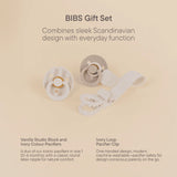 BIBS Gift Set featuring a pacifier clip and pacifier block set in ivory and light gray, presented on a warm beige background with descriptive text.