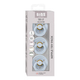 BIBS Try-It Collection Nipple Try It Pack containing three pacifiers in natural rubber with light blue shields and gold centers, shown in its original packaging.