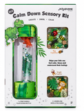 Jellystone Calm Down Sensory Kit in its retail packaging, featuring a green dinosaur-themed bottle with colorful inner layers and two sample window views showing insect and jungle confetti designs.