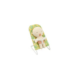 A plush baby doll with a cream-colored body and pink nose, seated in a green and yellow floral-patterned high chair with white metal legs, isolated on a white background.