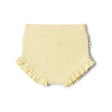 Yellow baby bloomers with ruffled edges on a white background