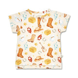 A short-sleeve baby t-shirt with a western-themed print on a cream background, featuring watercolor-style illustrations of cowboy boots, hats, lasso, stars, and blocks.