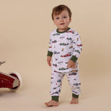 Child wearing pajamas with car pattern on a beige background