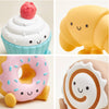 Four cute silicone food-shaped toys arranged in a grid on a light background.