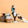 Set of small animal figurines on a beige background