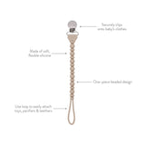 Beige pacifier clip with text describing its features on a white background