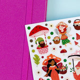 Sheet of fairy and gnome stickers with a purple notebook