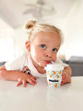 Child drinking from a cup with 'bbeeino' branding