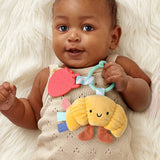 Baby holding a colorful toy with a soft white background