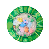 Colorful toy fish in a small round container with a green and yellow patterned lid.