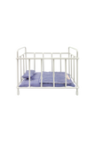 White crib with blue checkered mattress and pillow on a white background