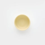 Yellow ceramic bowl on a white background