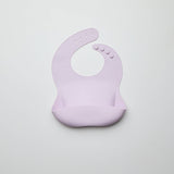 Purple silicone bib on a light gray background