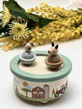 Wooden toy with animal figures on a decorative base with floral background