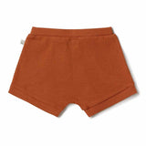 Orange ribbed shorts on a white background