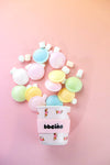 Pastel-colored bubblegum in a cup with 'bbeeino' branding on a pink background